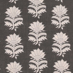 Detail of fabric in a repeating thistle print in cream and gray on a charcoal field.