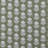 Detail of fabric in a repeating thistle print in white and blue on a green field.
