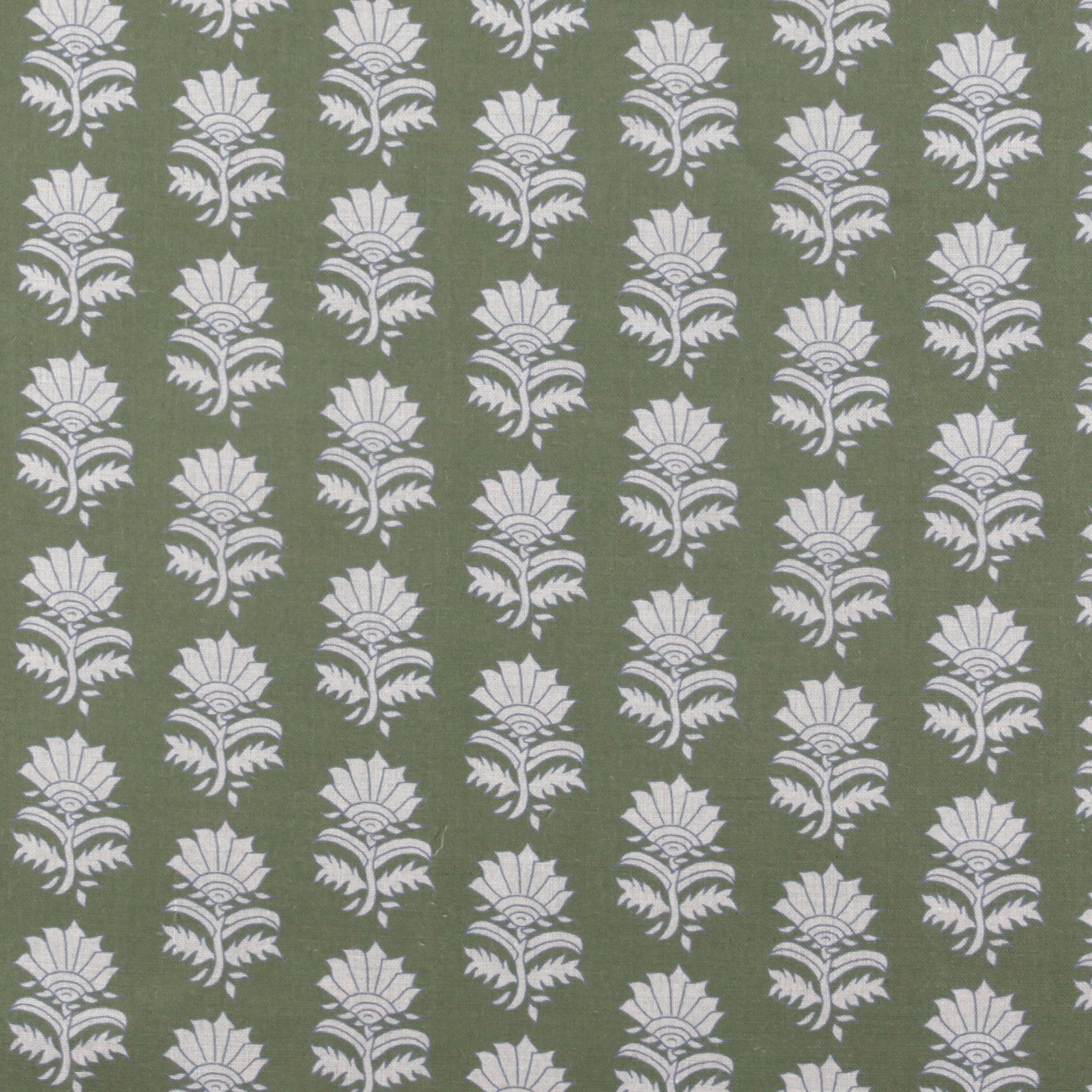 Detail of fabric in a repeating thistle print in white and blue on a green field.