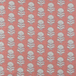 Detail of fabric in a repeating thistle print in white and blue on a pink field.