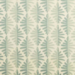 Detail of fabric in a fern leaf print in shades of green on a cream field.
