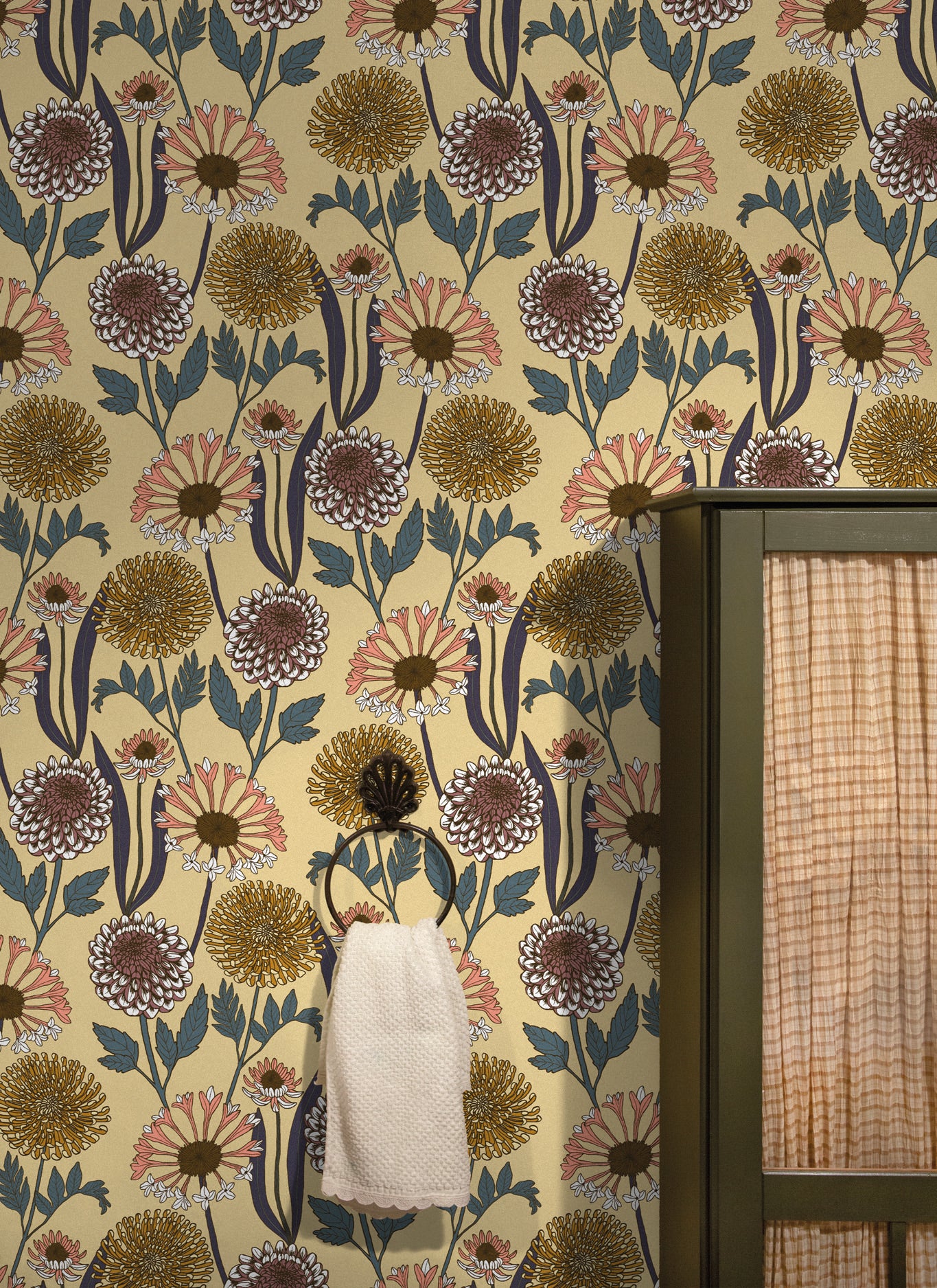 Floral wallpaper with a towel hanging on a hook