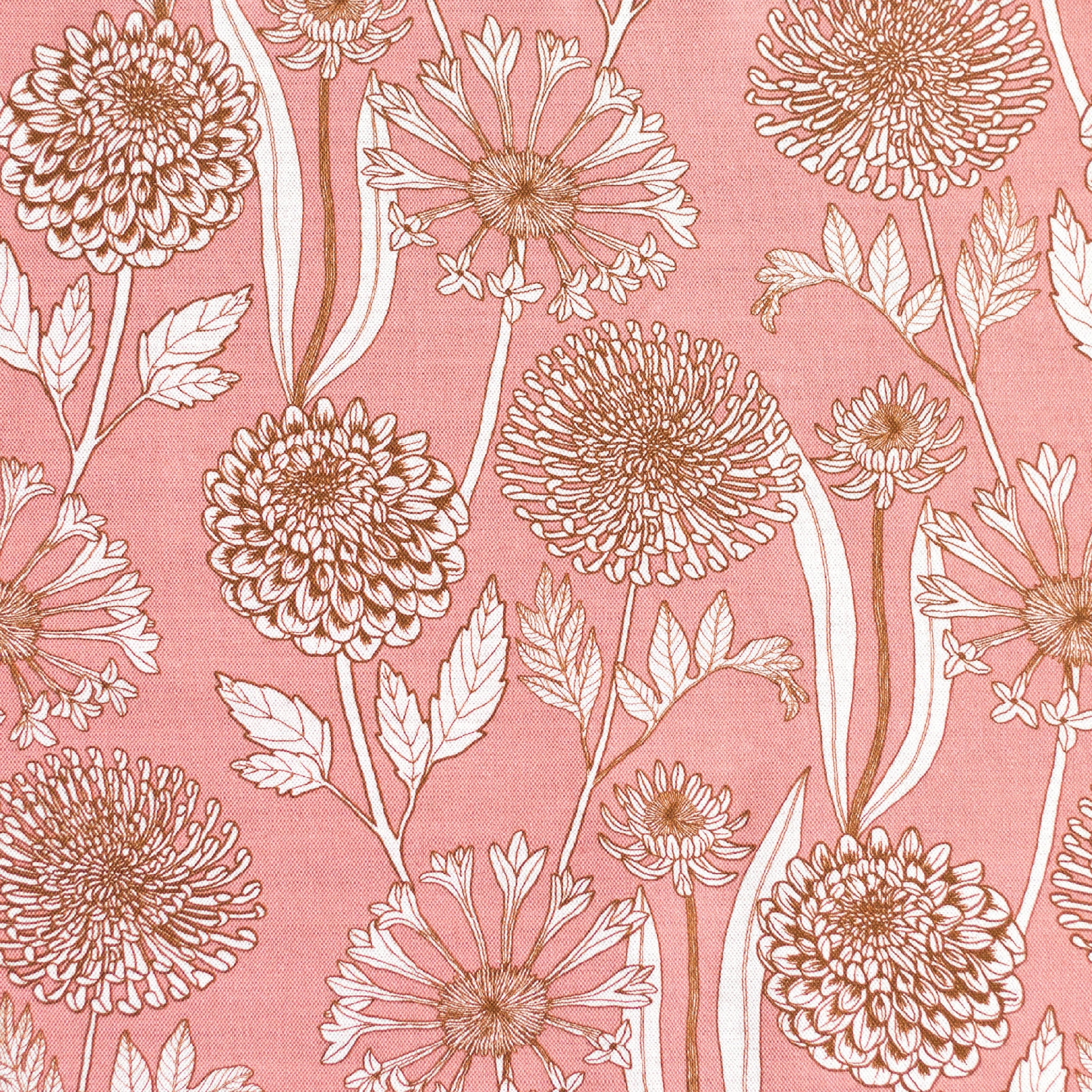 Detail of fabric in a large-scale floral print in orange and white on a light pink field.