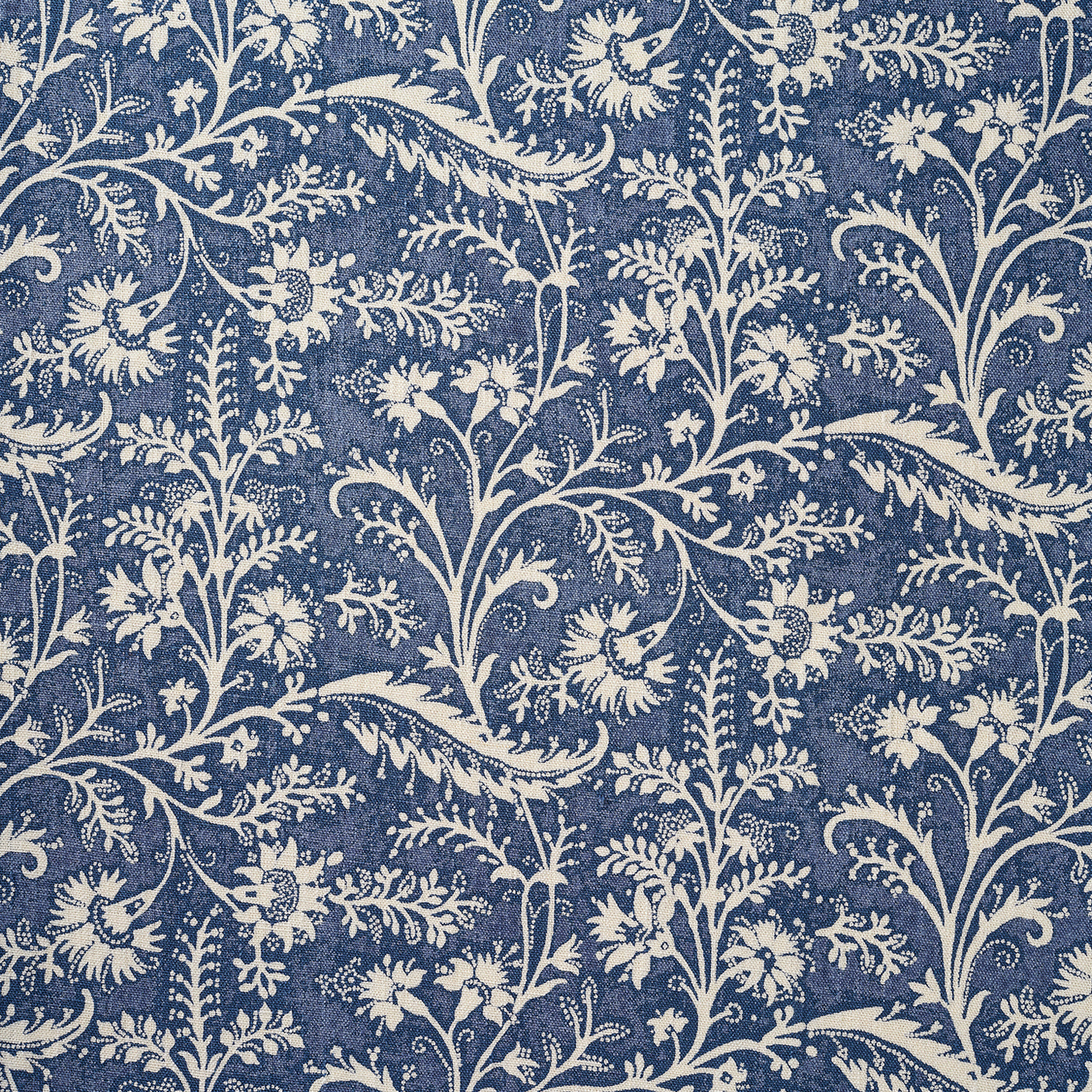 A close-up of a repeating floral and vine pattern in muted denim blue and off-white.