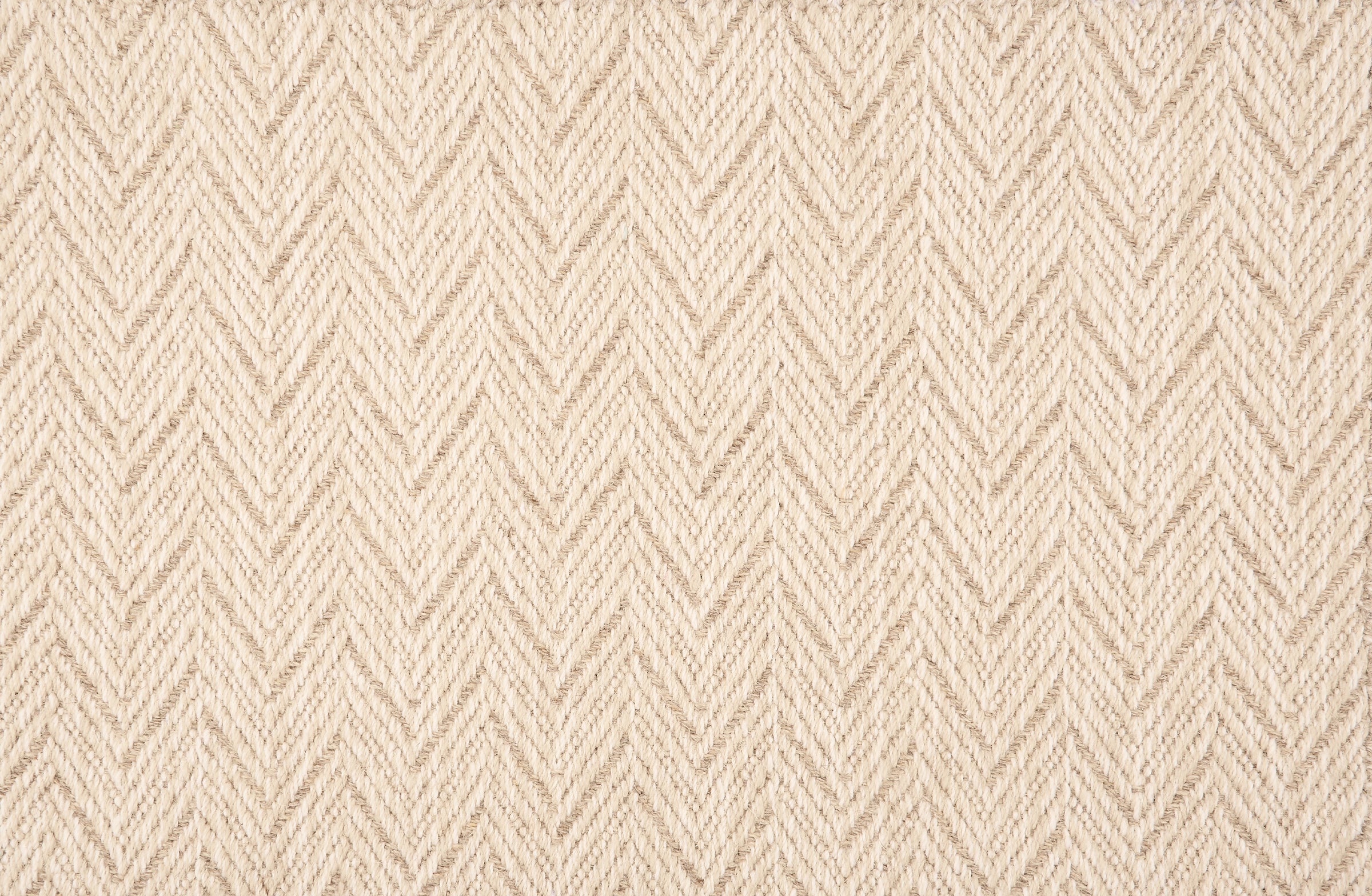 Broadloom carpet in a herringbone pattern in cream with beige accents.