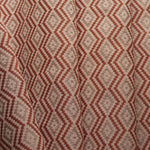 Close-up of fabric with red and beige zigzag pattern