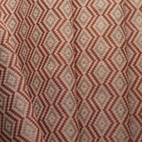 Close-up of fabric with red and beige zigzag pattern