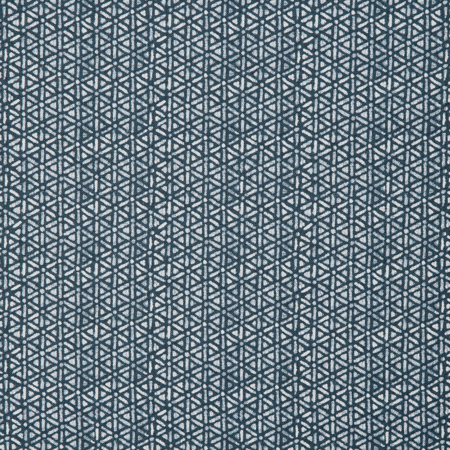 Detail of a linen fabric in a detailed geometric pattern in white on an indigo field.