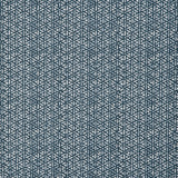 Detail of a linen fabric in a detailed geometric pattern in white on an indigo field.