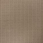 printed linen fabric in a detailed geometric pattern in white on a dark brown field.