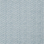 Detail of a linen fabric in a detailed geometric pattern in white on a light blue field.