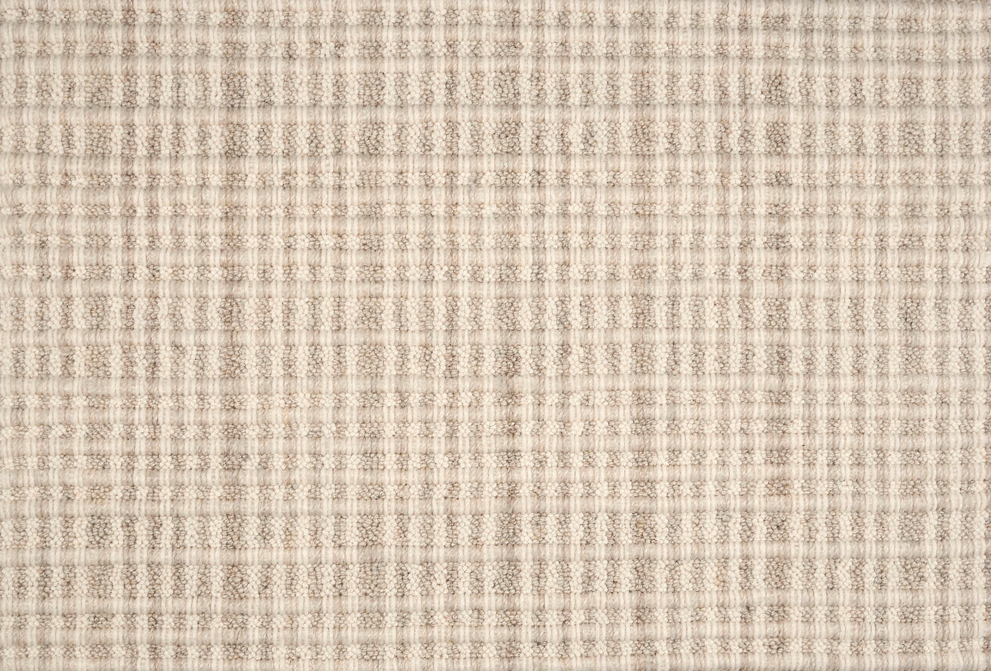 Broadloom carpet in textured stripe in striated oatmeal and cream.