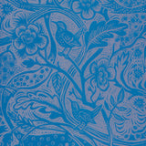Detail of wallpaper in a playful wren and flower print in blue and mauve.
