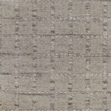 Broadloom carpet with raised gridded plaid in shades of grey and cream on a pale grey field.