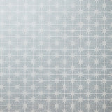 Detail of wallpaper in a geometric damask print in cream on a light blue field.