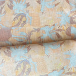 Draped fabric in painterly tropical checkerboard design in yellow, tan and blue. 