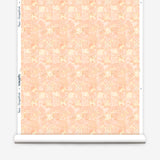 Roll of wallpaper in painterly tropical checkerboard design in pinky orange and yellow. 