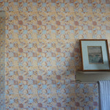 Tropical Check patterned wallpaper with a framed picture and towel on a shelf.