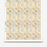 Wallpaper roll in painterly tropical checkerboard design in yellow, tan and blue. 