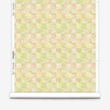 Wallpaper roll in painterly tropical checkerboard design in lime green, yellow and orange. 