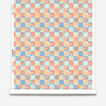 Roll of wallpaper in painterly tropical checkerboard design in blue, coral and orange. 