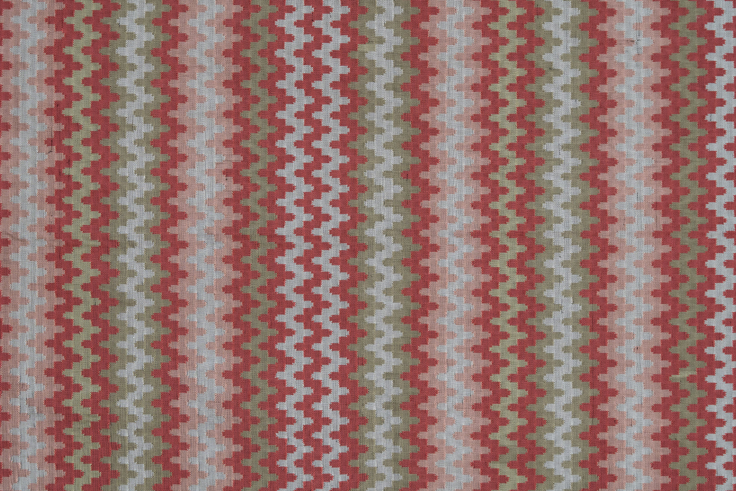 Handwoven silk fabric with zigzag design  in red, green, and beige.