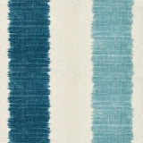 Detail of fabric in an ikat stripe print in shades of blue on a cream field.