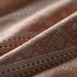 Close-up of textured brown fabric with geometric pattern