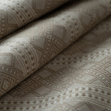 Close-up of textured beige fabric with geometric pattern