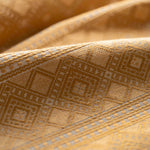Close-up of textured fabric with geometric pattern in yellow