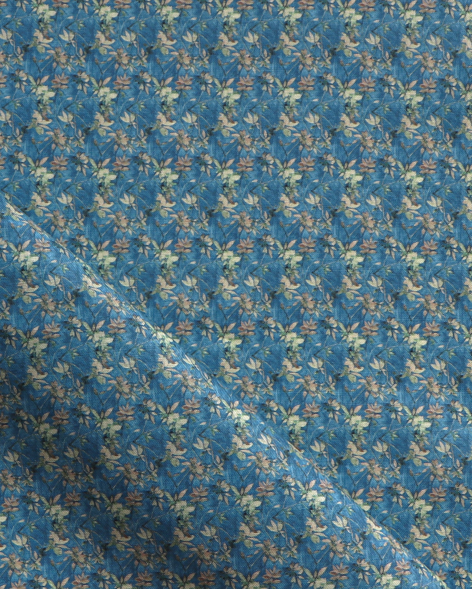 Fabric with small scale watercolor floral in green on teal.
