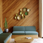 Modern living room with wooden walls, teal sofa, and decorative wall art.