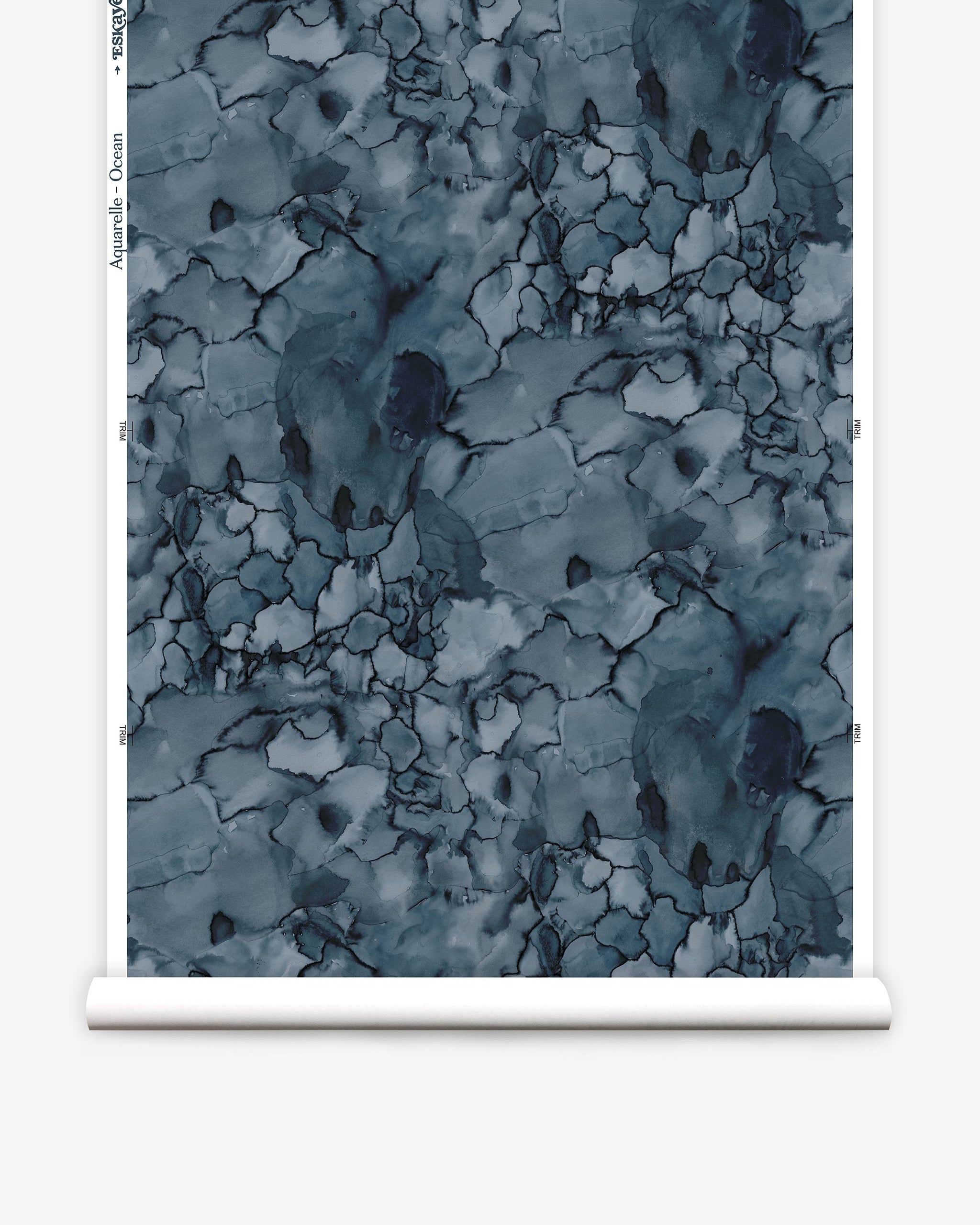Partially unrolled wallpaper yardage in a watercolor textural print in shades of blue, navy and black.