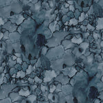Detail of wallpaper in a watercolor textural print in shades of blue, navy and black.
