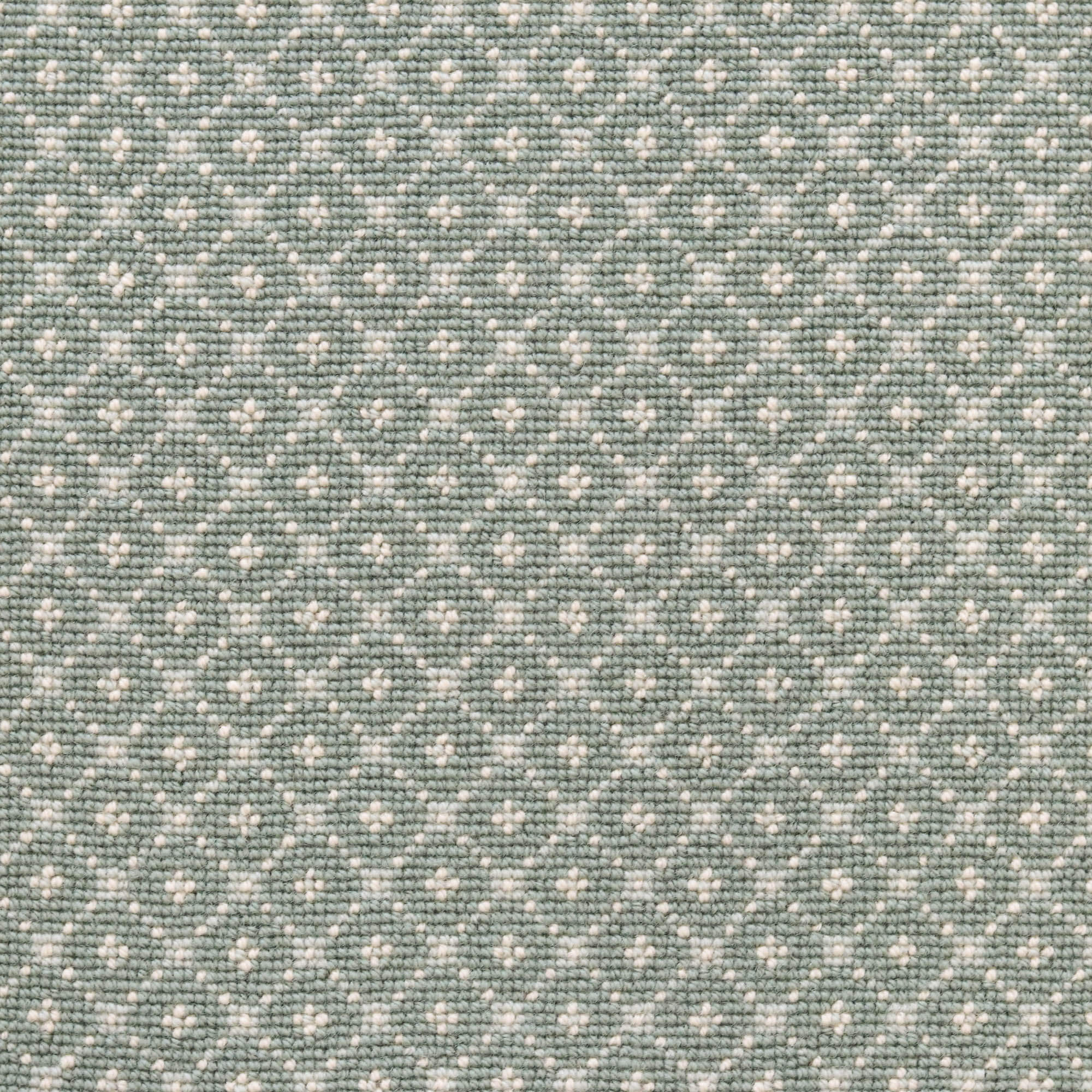 Broadloom carpet with dotted lattice in cream on an aqua blue field. 