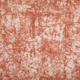 Detail of velvet fabric in an organic crumpled texture in coral on a cream field.