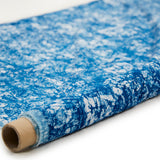 Partially unrolled fabric in an organic crumpled texture in navy on a cream field.