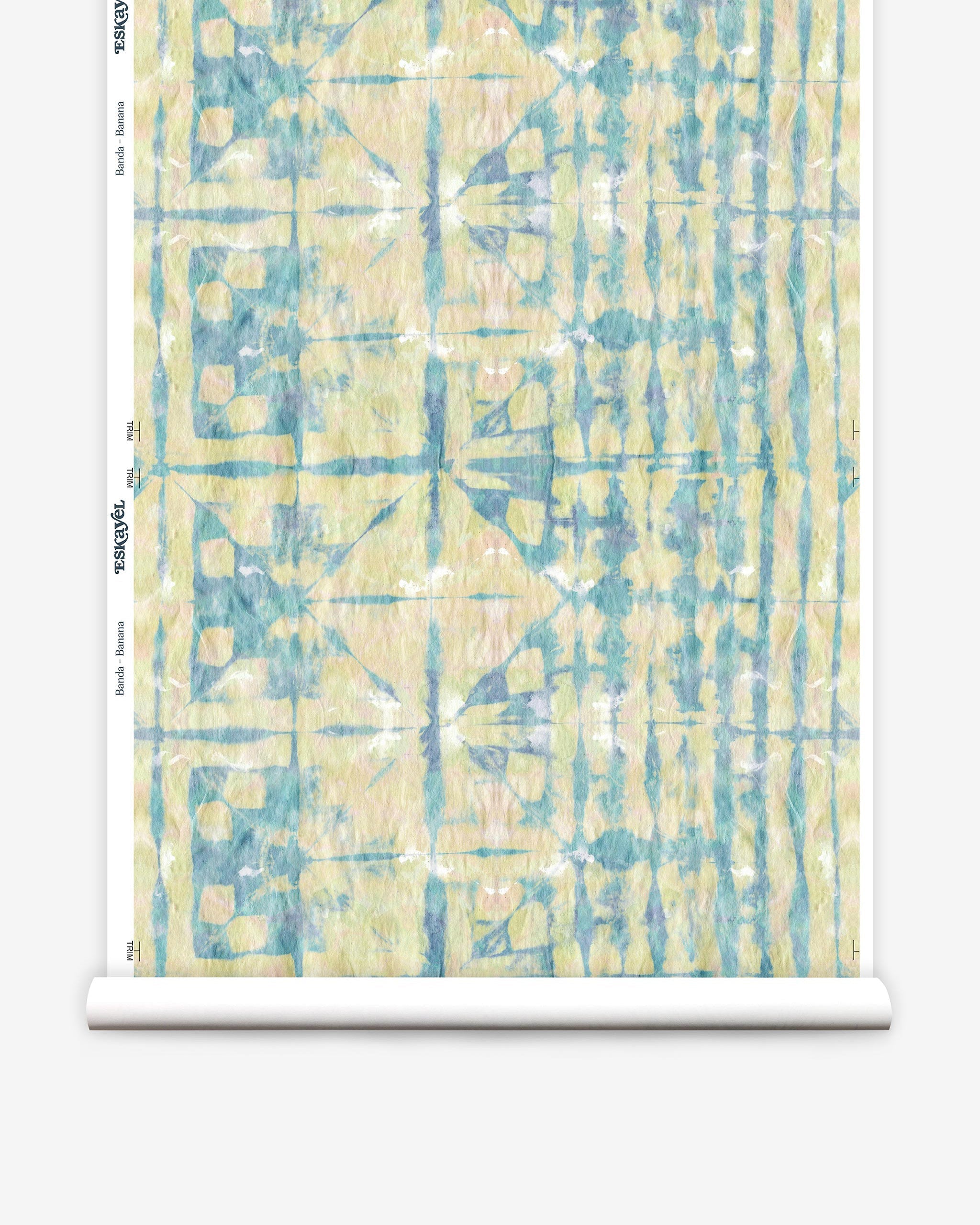 Partially unrolled wallpaper yardage in a watercolor dyed grid print in mottled yellow, blue and white.
