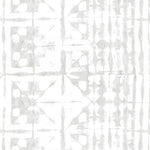 Detail of wallpaper in a watercolor dyed grid print in mottled white and gray.