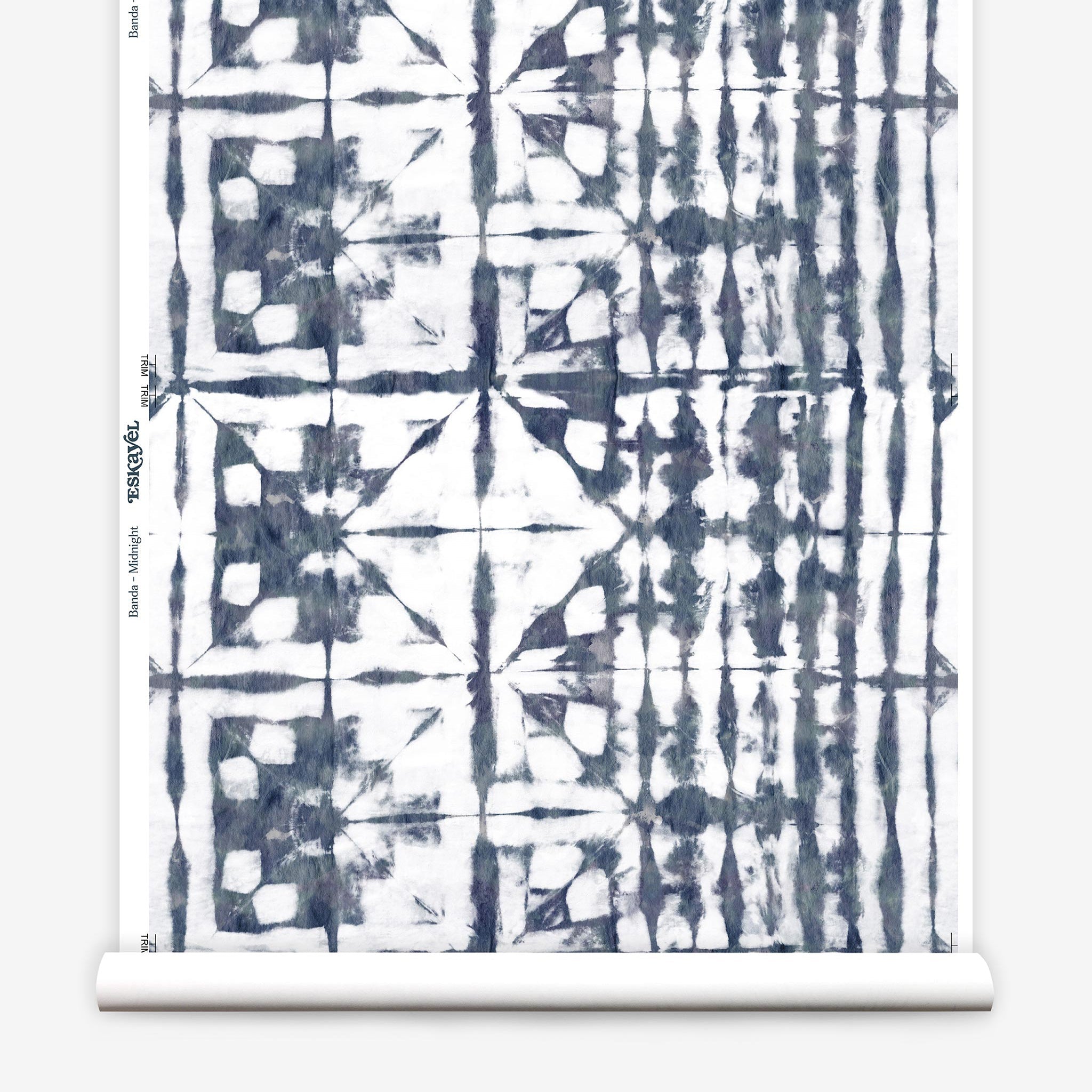 Partially unrolled wallpaper yardage in a watercolor dyed grid print in mottled white and navy.