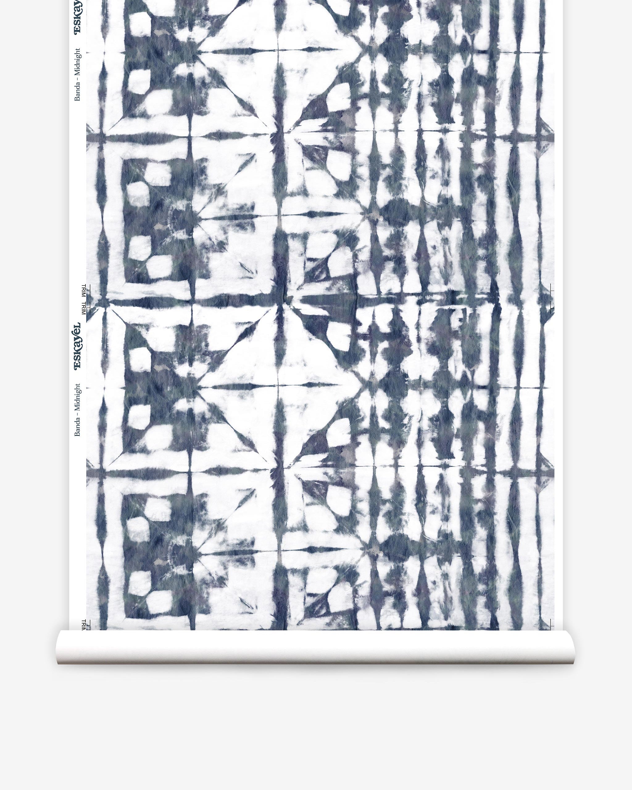 Partially unrolled wallpaper yardage in a watercolor dyed grid print in mottled white and navy.