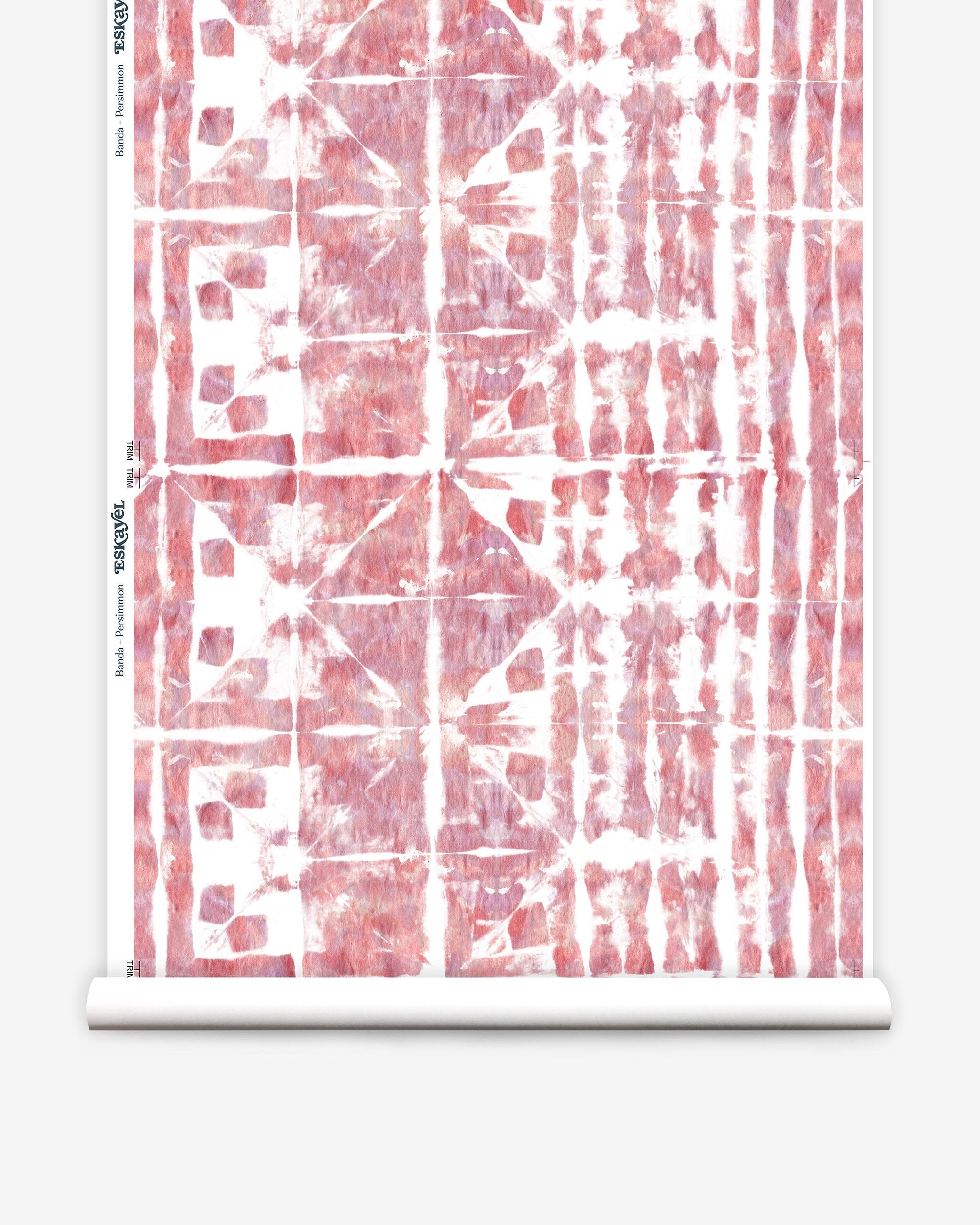 Partially unrolled wallpaper yardage in a watercolor dyed grid print in mottled white, pink and red.