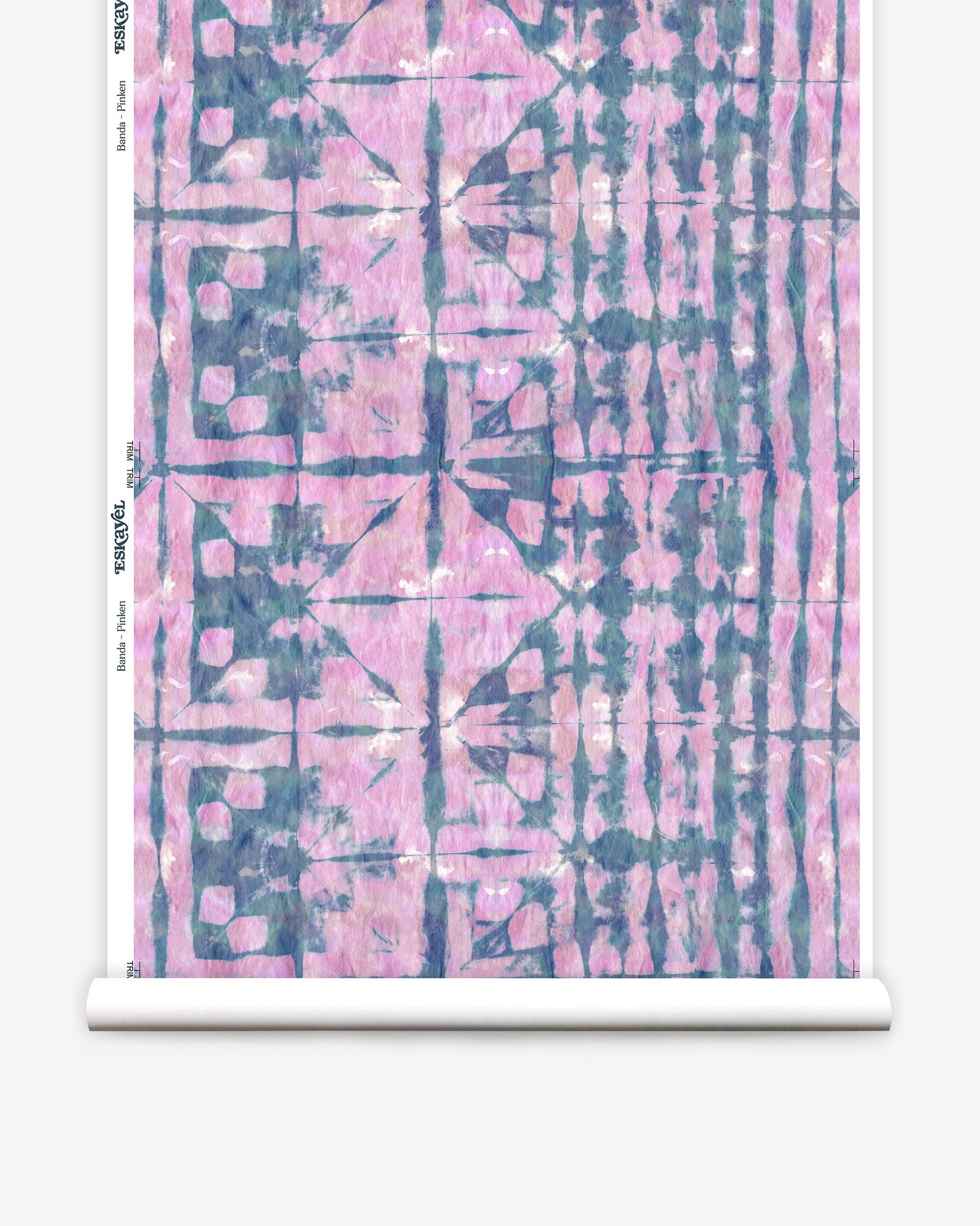Partially unrolled wallpaper yardage in a watercolor dyed grid print in mottled pink and navy.