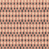 Detail of wallpaper in a geometric check print in shades of pink, tan and black.