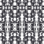 Detail of wallpaper in a painterly ikat print in black on a white field.