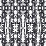Detail of wallpaper in a painterly ikat print in black on a white field.