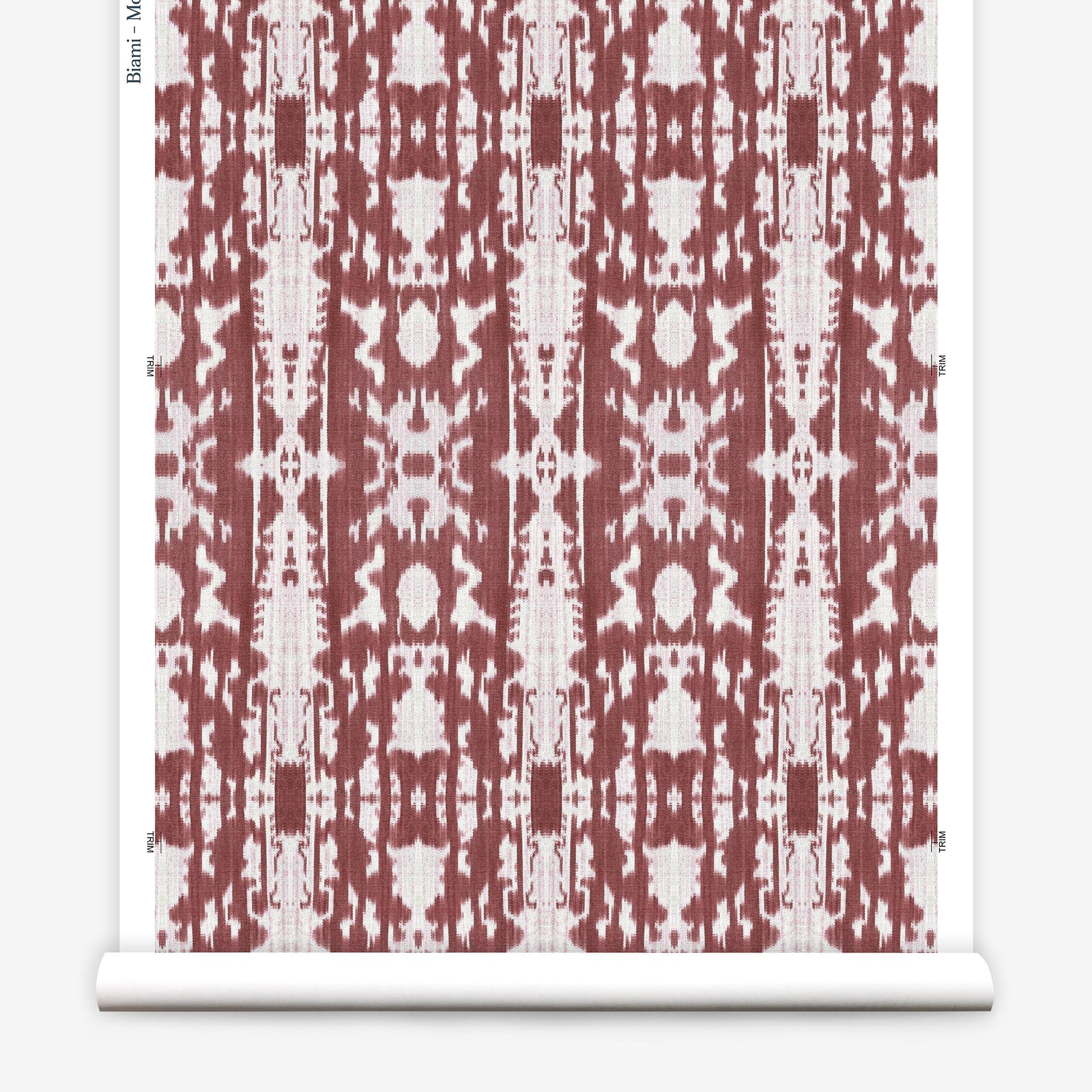 Partially unrolled wallpaper yardage in a painterly ikat print in rust and white.