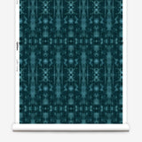 Partially unrolled wallpaper yardage in a painterly ikat print in turquoise and navy.