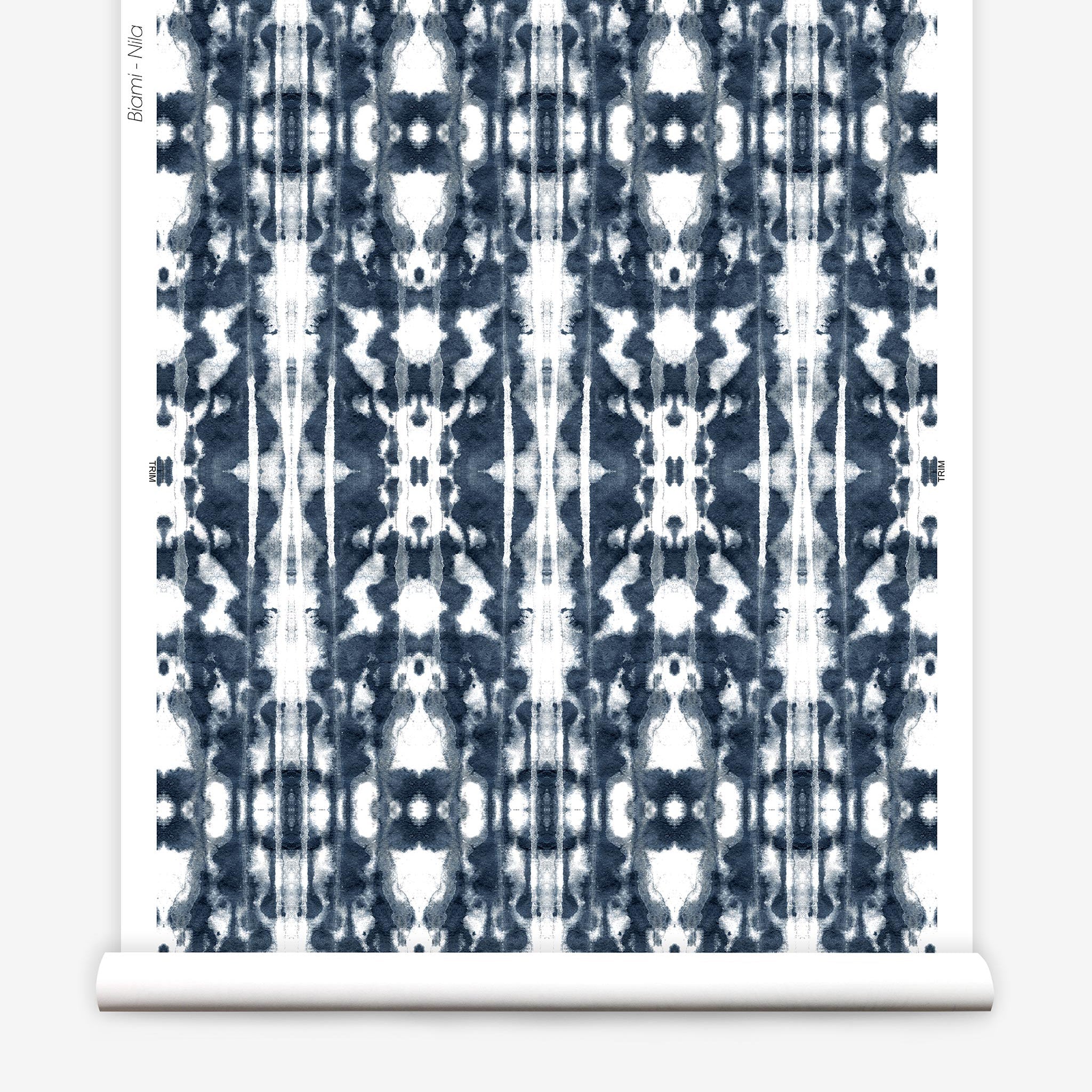 Partially unrolled wallpaper yardage in a painterly ikat print in navy and white.