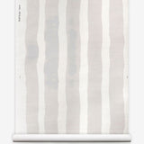 Grasscloth wallpaper roll with bold watercolor stripes in beige and white on a white background.